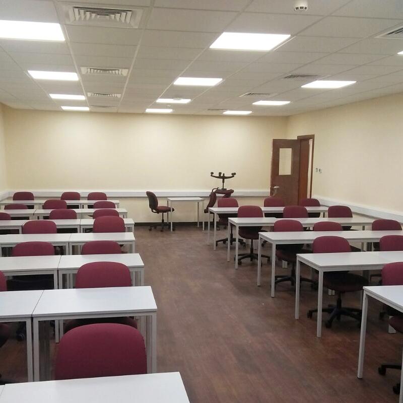 photograph of dark wooden laminate flooring inside sharjah university classroom
